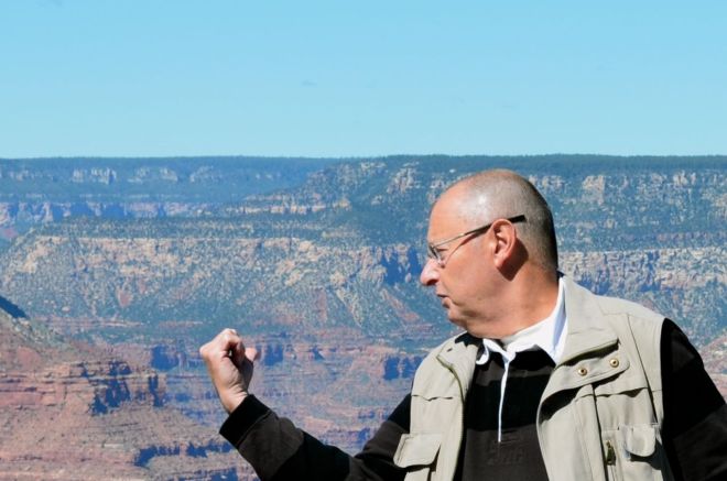 Poser pointing to the backdrop South Rim