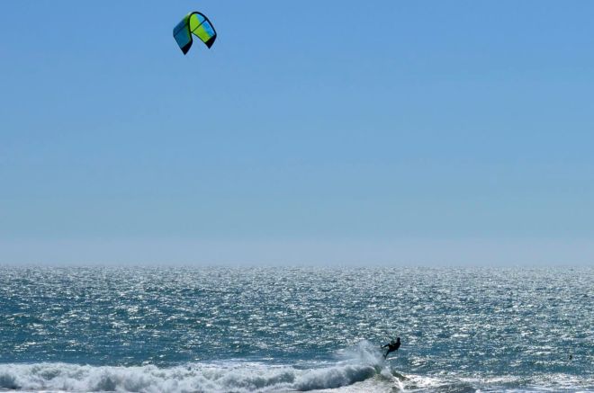 Wind surfer jumping wave