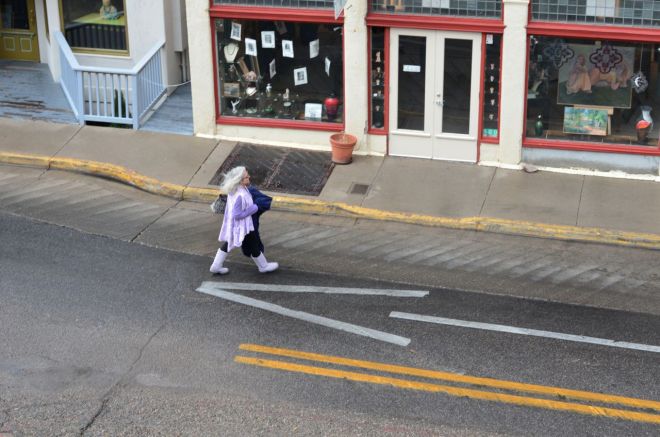Gray-haired lady on street below